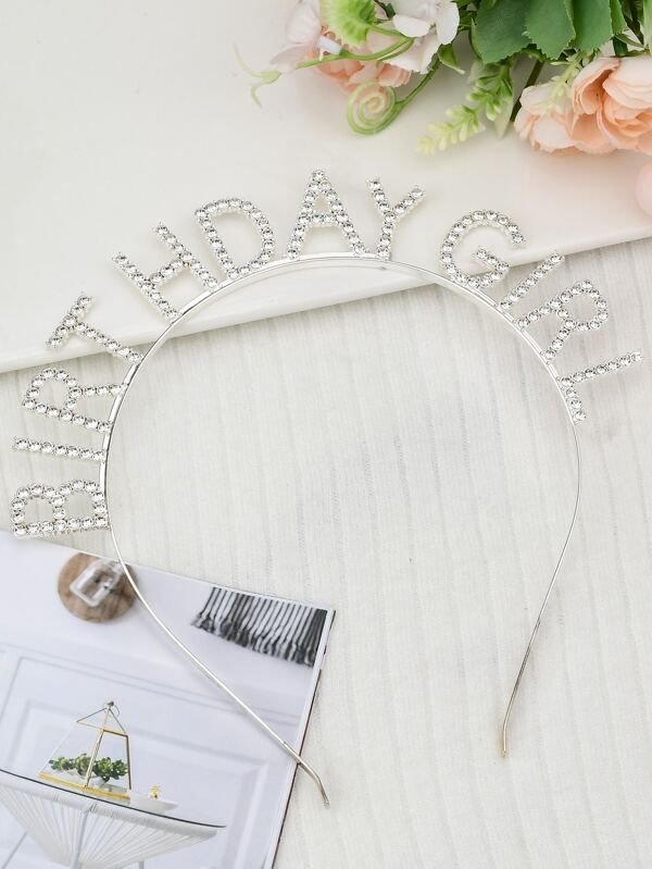 Close-up of our 'Birthday Girl' diamante silver headband, with a white background. This eye-catching headband is perfect for birthday celebrations and adding a touch of glamour