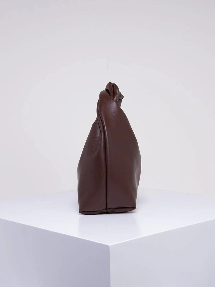 Our rich Chocolate PU leather bag show from side on, against a white background. Highlighting the depth of the bag. Luxurious and practical addition for work or dinner dates