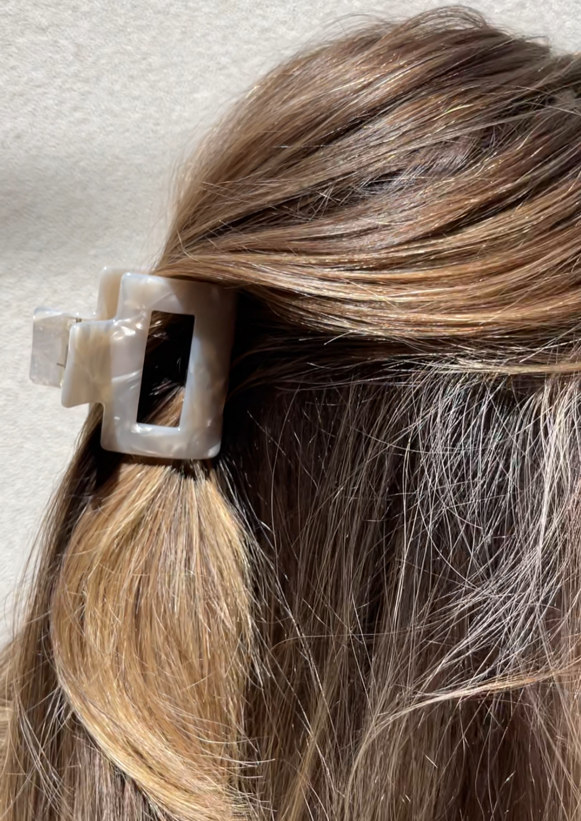 Close up of our Feur hair clip in a womans hair. Highlighting the sheen of the ivory marbled resin. Perfect for bridal parties
