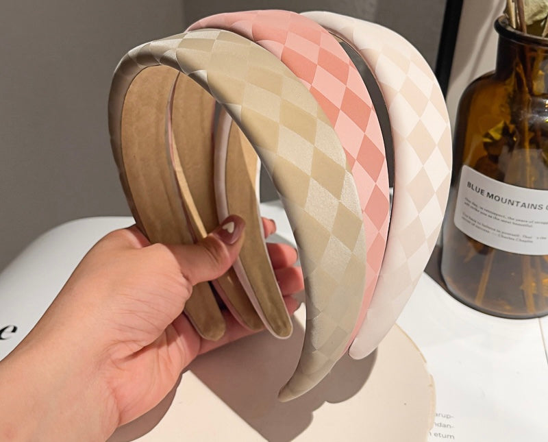 Three Dahlia headbands being held for colour comparisons, from left to right, we have Latte, Dusty Pink, Cream. Elegant satin material wrapped the band with a soft checked shade pattern. Perfect for adding texture and neutral tones to any outfit. Spring races, date night or casual day attire
