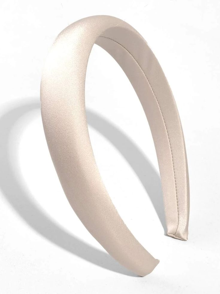Our Creme headband against a white background, you can see the seam detail on the underside of the satin wrapped padded headband. Highlighting the padded band and sheen of the satin/silk material. Perfect for a bride or bridesmaid at a hen event or wedding day