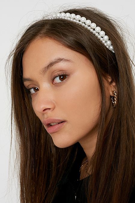 A woman wearing our Daisy headband stacked next to another pearl headband. Our Daisy headband is the smaller of the two bands. Perfect for Brides or bridesmaids for wedding events