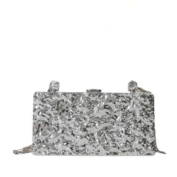 Close up of our Lexi Chrome Acrylic bag with shoulder chain attachment added. Showing the texture of the mirrored acrylic design. Versatile addition to any outfit for your next event