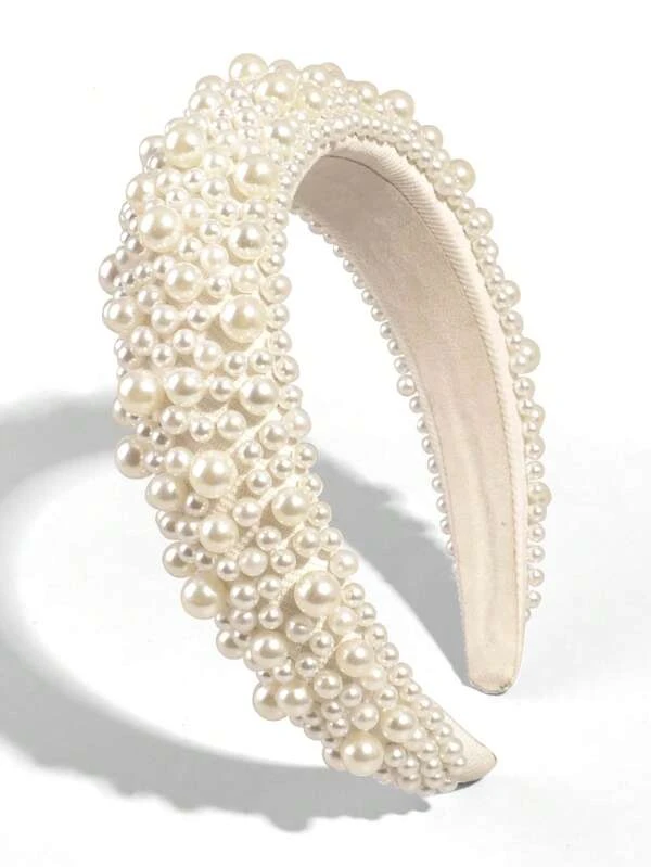 Our Peony Headband against a white background, with multiple sizes of faux pearls across the padded cream band. Highlighting the sheen of the pearls and angle shows the height of the band. Perfect bride or bridesmaid accessory