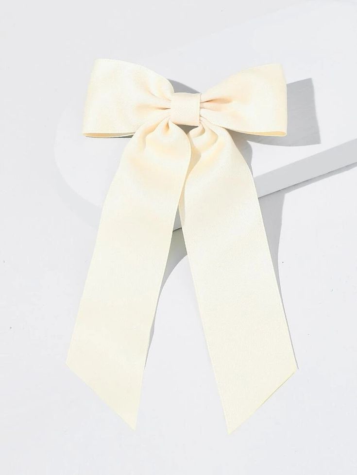 Our Rose Bow Velvet Hair Clip, shown against a white background, highlighting the cream colour and shape of the bow. Gorgeous addition for any bride to be