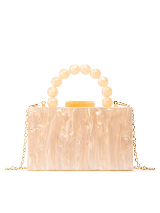 A stylish apricot-coloured acrylic clutch  box bag with a glossy finish, featuring a modern rectangular design. The handle is a beaded acrylic design, with a shoulder chain attached. Perfect for your next event.