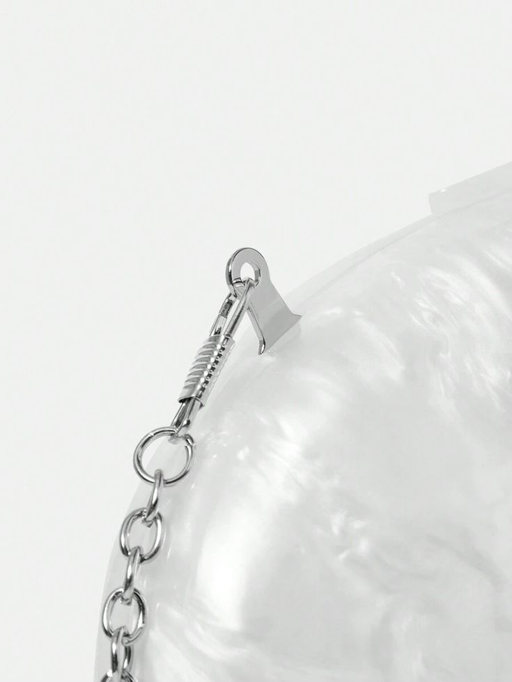 Close-up of the attached silver shoulder chain on our Ariel acrylic clutch 
bag. Highlighting that you can use this as a clutch or over the shoulder bag. The perfect elegant accessory for brides