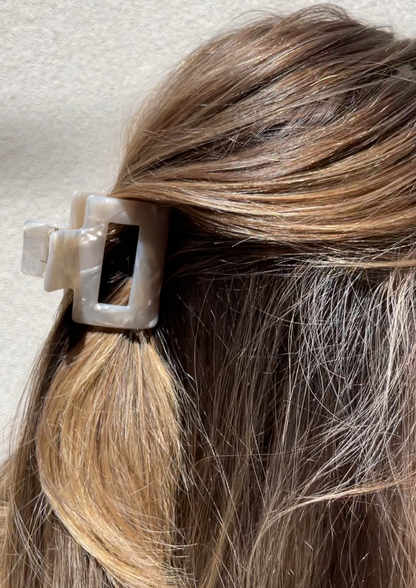 Close up of our Feur hair clip in a womans hair. Highlighting the sheen of the ivory marbled resin. Perfect for bridal parties 