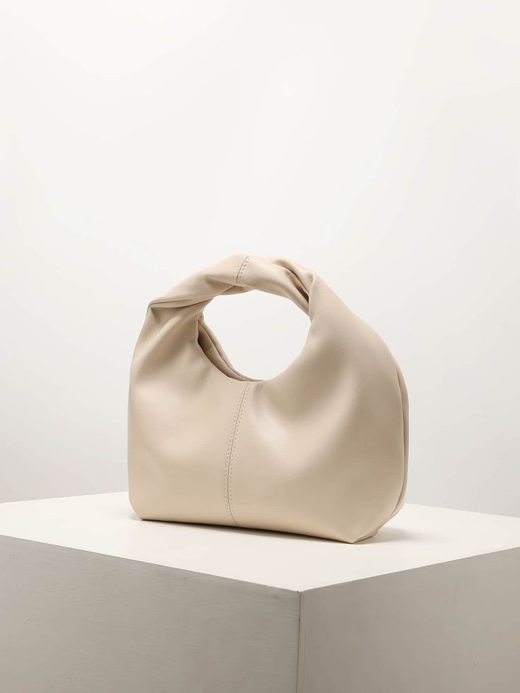 Soft cream handbag with ruched design and top handle, elegant bridal and event accessory by CORAL & CO.