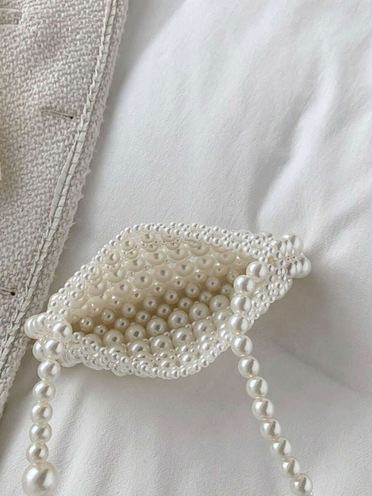 A birdseye view of our Gigi bag open, showing the pure pearl beaded design that can hold all your essentials for your next wedding event.