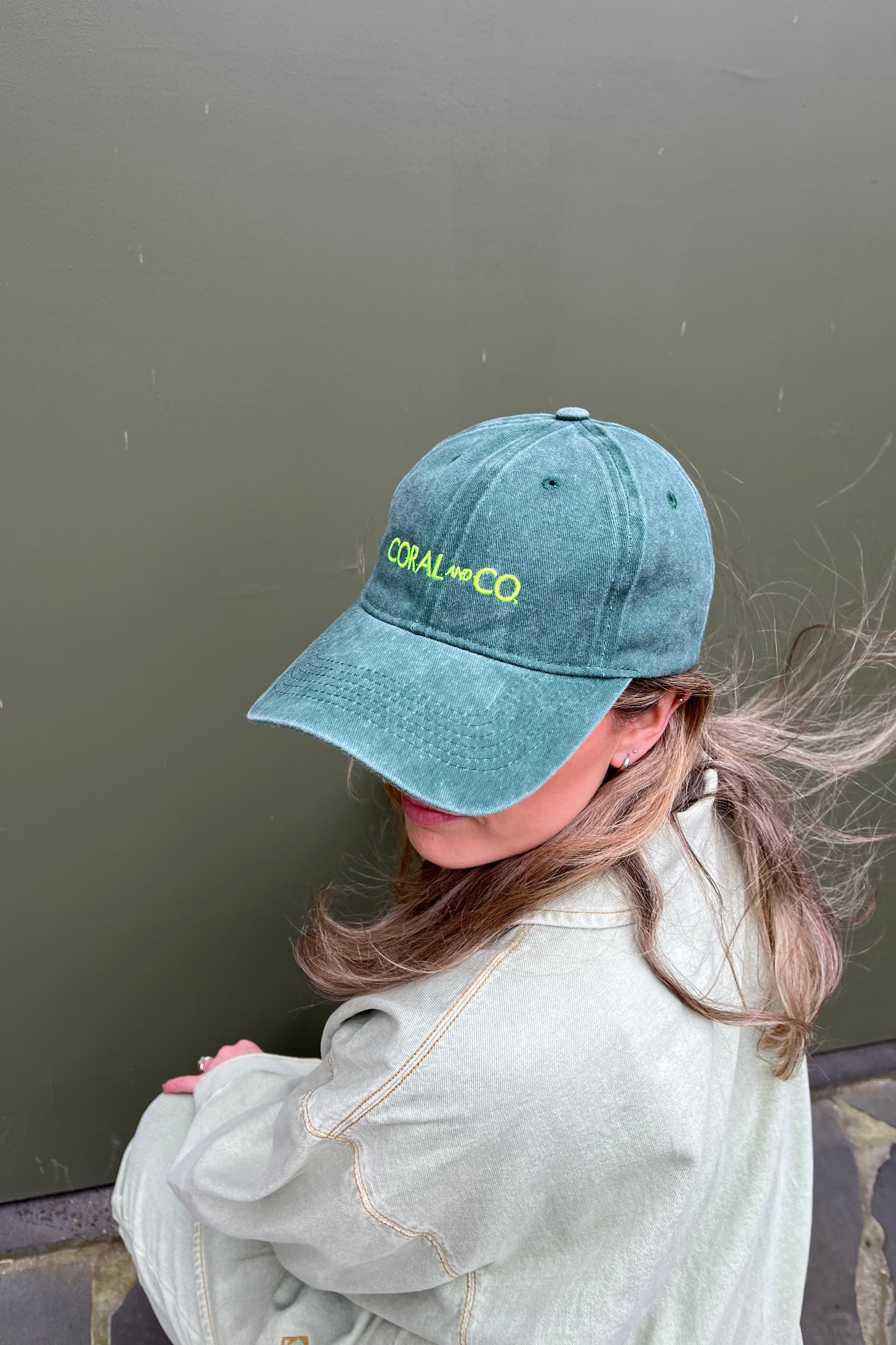 Coral wearing our Green Goddess Cap. Dark green faded denim and featuring a bold fluro green embroidery. Perfect for casual daily wear