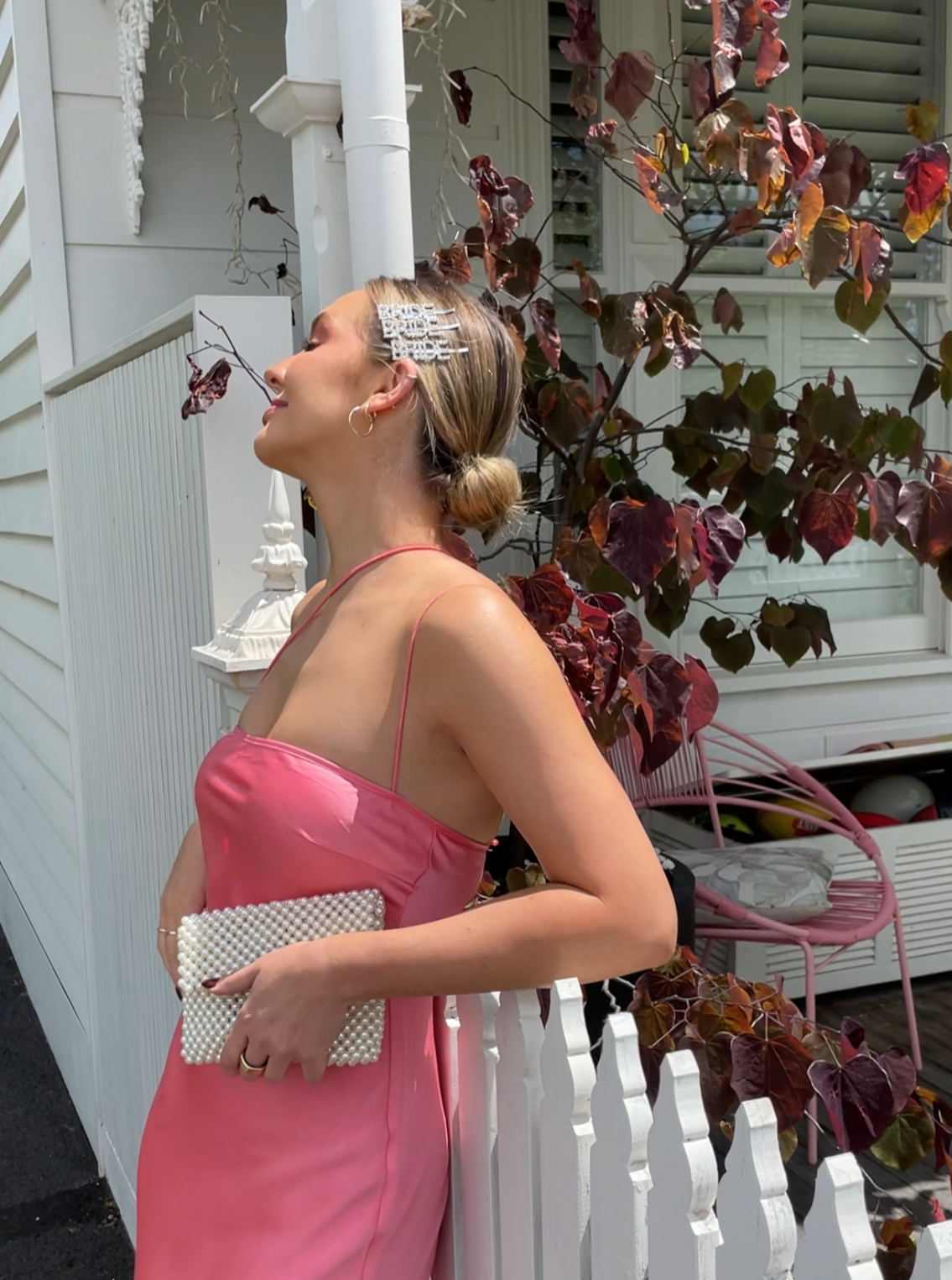 Kelly wearing our silver 'Bride' Diamante Hair Clip. Showing a profile view of her hair in a low bun and 3 'BRIDE' clips in her hair above her ear. Highlighting the sparkle that the diamante detail catches in the sunlight. Perfect for all things wedding