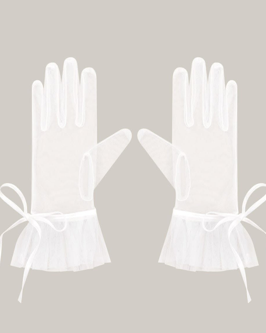pair of translucent sheer white wedding gloves with a romantic wrist bow and frilled edges, styled for a chic drama or Bridgerton-inspired bridal aesthetic.
