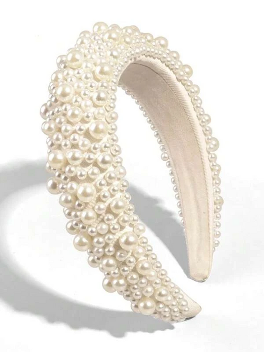 Our Peony Headband against a white background, with multiple sizes of faux pearls across the padded cream band. Highlighting the sheen of the pearls and angle shows the height of the band. Perfect bride or bridesmaid accessory 