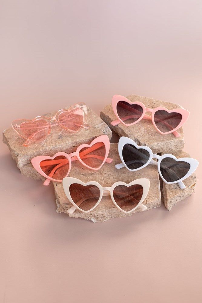A collection of our 5 colour ways of our heart shaped glasses. Pink on pink are second from the top and on the left. Against a pink background, highlighting the various colour-ways. Perfect for bride or bridesmaids at your next hen party